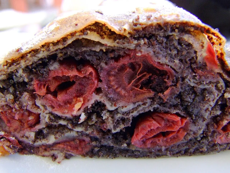 Разрез штруделя с маком и вишнями под сахарной пудрой